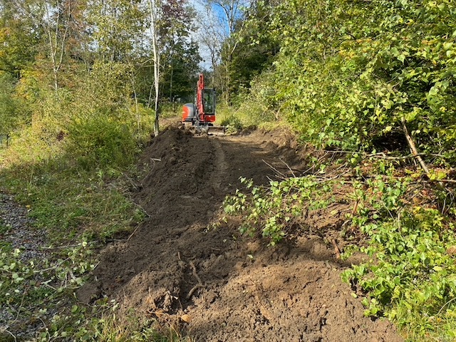 Building an access road for the property owner using a mini-excavator